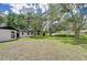 Property showing a lush backyard and the home's exterior at 4911 Country Aire Ln, Tampa, FL 33624
