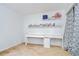 This bedroom features two white desks, floating shelves with decor, carpet and a window with patterned curtains at 4911 Country Aire Ln, Tampa, FL 33624