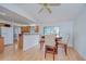 The dining room shows a wooden table set with an open view into the bright kitchen at 4911 Country Aire Ln, Tampa, FL 33624
