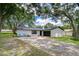 Beautiful single-story home with fresh exterior, black trim, and a spacious driveway at 4911 Country Aire Ln, Tampa, FL 33624