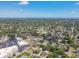 Wide aerial shot captures a dense residential area dotted with trees and commercial buildings, stretching to the distant ocean at 5010 8Th N Ave, St Petersburg, FL 33710