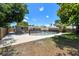 Large yard showcasing pool surrounded by fence, mature trees and patio space at 5010 8Th N Ave, St Petersburg, FL 33710