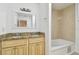 Bathroom featuring double sinks with granite countertop and a tiled bathtub at 5010 8Th N Ave, St Petersburg, FL 33710