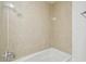 Tiled bathtub with shower featuring updated fixtures at 5010 8Th N Ave, St Petersburg, FL 33710