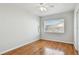 Bright bedroom featuring hardwood floors, a ceiling fan, and a window with blinds at 5010 8Th N Ave, St Petersburg, FL 33710