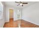 Bedroom featuring light wood floors, neutral walls, a closet and bathroom access at 5010 8Th N Ave, St Petersburg, FL 33710