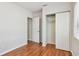 Bedroom featuring hardwood floors, neutral paint, a closet and adjacent entry way at 5010 8Th N Ave, St Petersburg, FL 33710