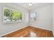 Bright bedroom featuring hardwood floors, large windows, and neutral paint at 5010 8Th N Ave, St Petersburg, FL 33710