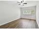 Spacious bedroom with a ceiling fan, wood flooring, and a bright window at 5010 8Th N Ave, St Petersburg, FL 33710