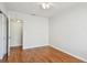 Cozy bedroom with hardwood floors, ceiling fan, and a view into an adjoining room at 5010 8Th N Ave, St Petersburg, FL 33710