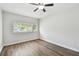 This bedroom features sleek, modern wood floors and a ceiling fan at 5010 8Th N Ave, St Petersburg, FL 33710