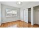 Bright bedroom featuring hardwood floors, large window, and closet with sliding doors at 5010 8Th N Ave, St Petersburg, FL 33710