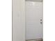 A standard six-panel white entry door, seen from the interior of the home at 5010 8Th N Ave, St Petersburg, FL 33710