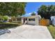 A well-maintained home with a private driveway, lush green yard and mature tree at 5010 8Th N Ave, St Petersburg, FL 33710
