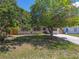 Home exterior with lush green lawn, mature trees, and a long driveway at 5010 8Th N Ave, St Petersburg, FL 33710