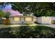 Charming home with landscaped front yard shaded by a mature tree; solar panels installed at 5010 8Th N Ave, St Petersburg, FL 33710