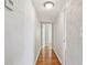 Long hallway with hardwood flooring and textured walls leading to other rooms at 5010 8Th N Ave, St Petersburg, FL 33710