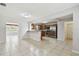 Bright, open kitchen with stainless steel appliances and granite countertops, adjacent to a tiled living area at 5010 8Th N Ave, St Petersburg, FL 33710