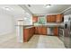 Well-lit kitchen with stainless steel appliances, wood cabinets, and granite countertops at 5010 8Th N Ave, St Petersburg, FL 33710