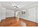 A well-lit living room with hardwood floors and an archway leading to a kitchen or dining area at 5010 8Th N Ave, St Petersburg, FL 33710