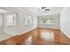 Bright living room with gleaming hardwood floors and a view of a window and doorway at 5010 8Th N Ave, St Petersburg, FL 33710