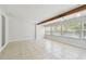Bright, open living room with tile flooring, beam, and abundant natural light at 5010 8Th N Ave, St Petersburg, FL 33710