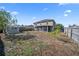 Expansive backyard featuring mature trees, a fire pit, and storage shed at 5236 Treig Ln, Wesley Chapel, FL 33545
