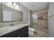 Modern bathroom featuring granite countertop, walk-in shower and elegant fixtures at 5236 Treig Ln, Wesley Chapel, FL 33545