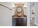 Powder room featuring vanity with vessel sink, decorative mirror, modern lighting and stylish fixtures at 5236 Treig Ln, Wesley Chapel, FL 33545