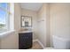 Powder room showcasing vanity with granite countertop and modern fixtures, alongside a toilet at 5236 Treig Ln, Wesley Chapel, FL 33545