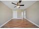 Bright and spacious bedroom with wood-look floors, ceiling fan, and large closet at 5236 Treig Ln, Wesley Chapel, FL 33545