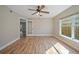 Bedroom featuring wood floors, a ceiling fan, natural light, and an entry to another room at 5236 Treig Ln, Wesley Chapel, FL 33545
