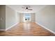 Bright bedroom featuring wood flooring, neutral walls, a ceiling fan, and a window with natural light at 5236 Treig Ln, Wesley Chapel, FL 33545
