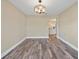 Dining room featuring wood floors, neutral walls and modern light fixture, providing an inviting atmosphere at 5236 Treig Ln, Wesley Chapel, FL 33545