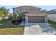 Charming two-story home with a well-manicured lawn, two-car garage and mature trees in a Gathering-friendly neighborhood at 5236 Treig Ln, Wesley Chapel, FL 33545