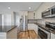 Well-equipped kitchen featuring stainless steel appliances, white cabinetry, and granite countertops at 5236 Treig Ln, Wesley Chapel, FL 33545
