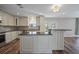Modern kitchen with stainless steel appliances, granite countertops, a center island, and white cabinetry at 5236 Treig Ln, Wesley Chapel, FL 33545