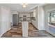 Bright kitchen featuring a large island, stainless appliances, and ample storage at 5236 Treig Ln, Wesley Chapel, FL 33545