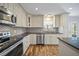 Modern kitchen with stainless steel appliances, stylish backsplash, and wood-look flooring at 5236 Treig Ln, Wesley Chapel, FL 33545