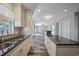 Spacious kitchen with an island bar, stylish backsplash, and wood-look flooring at 5236 Treig Ln, Wesley Chapel, FL 33545