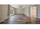 Open living room with hardwood floors, recessed lighting, ceiling fan and large window, perfect for entertaining at 5236 Treig Ln, Wesley Chapel, FL 33545