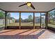 Screened patio offering backyard views, with tile flooring and a ceiling fan for outdoor relaxation at 5236 Treig Ln, Wesley Chapel, FL 33545