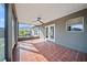Screened-in patio with ceiling fan, tile floors, and access to the backyard at 5236 Treig Ln, Wesley Chapel, FL 33545