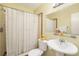 Charming bathroom featuring a pedestal sink, white floral shower curtain, and a decorative rubber duck at 5250 12Th N St, St Petersburg, FL 33703