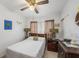 Cozy bedroom with neutral walls, a ceiling fan, and charming decor at 5250 12Th N St, St Petersburg, FL 33703
