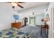 Spacious bedroom with a ceiling fan, walk-out access, and plenty of natural light at 5250 12Th N St, St Petersburg, FL 33703