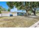Side exterior of home with a spacious yard and mature trees, perfect for outdoor living and activities at 5250 12Th N St, St Petersburg, FL 33703