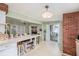Well-lit kitchen featuring a breakfast bar, brick wall, and sliding glass doors to the patio at 5250 12Th N St, St Petersburg, FL 33703