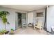 Relaxing covered patio with comfortable rocking chairs, a sliding glass door, and a view of the backyard at 5250 12Th N St, St Petersburg, FL 33703