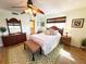 Inviting bedroom featuring a ceiling fan, wooden floors, and a comfortable ambiance with natural light at 5900 Shore S Blvd # 512, Gulfport, FL 33707